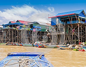 Colorful boats and stilt houses in Kampong Phluk floating village, Tonle Sap lake, Cambodia