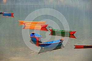 Colorful boats and their reflections on phewa lake