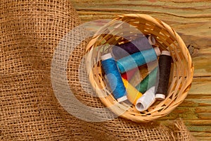 Colorful bobbins of thread in the weaven basket