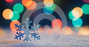 colorful, bokeh background. The snowflake exhibits intricate, symmetrical patterns and appears to be made of ice or crystal