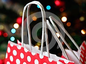Colorful bokeh Christmas background and paper gift bags