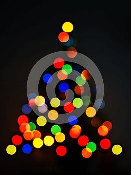 colorful bokeh of Christmas tree black background