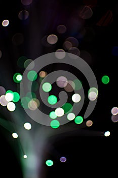 Colorful bokeh circle light celebrate at night, defocus light abstract green background.