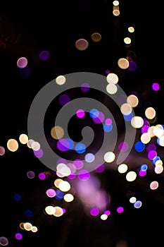 Colorful bokeh light celebrate at night, defocus light abstract background.