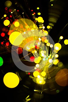 Colorful bokeh light celebrate at night, defocus light abstract yello background.