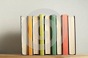 Stack of colorful books on wooden desk. Copy space for text. Back to school. Education background