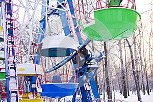 Colorful booths of ferris wheel under the snow