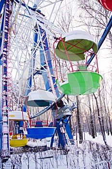 Colorful booths of ferris wheel under the snow