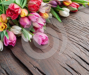 Colorful  bouquet of tulips on old wooden background