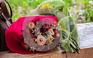 Colorful bouquets of flowers to pay homage to someone resting on a stone plain