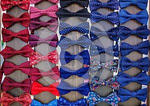 Colorful bow ties are located in the window.