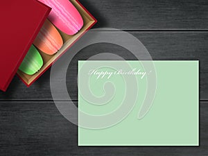 Colorful box French macaroons and blank birthday postcard