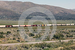 Colorful boxcars on a freight train on the high desert