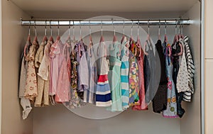 Colorful brand new baby girl clothes inside closet