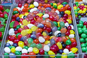 Colorful bright chewy candies covered with sugar. Rainbow ribbon candies. Colorful jelly candies close up as a bright joyful