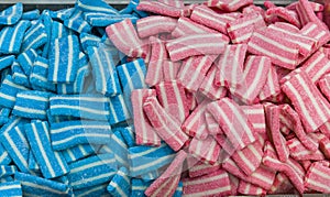 Colorful bright chewy candies covered with sugar. Rainbow ribbon candies. Colorful jelly candies close up as a bright joyful