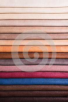 Colorful and bright fabric samples of furniture and clothing upholstery. Close-up of a palette of textile abstract