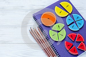 Colorful bright fractions in mathematics on white wooden table. interesting math for kids children. Education, back to school