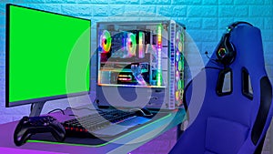 Colorful bright illuminated rgb gaming pc with keyboard mouse monitor and chair with racing  screen in front of LED light brick