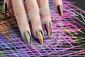 Colorful bright manicure with different sharp shape of nails framed with black lacquer.Nail art.