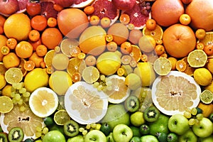 Colorful bright rainbow background of fresh ripe sweet citrus fruits