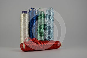 Colorful bright tone thread spools isolated on a white. Red on front