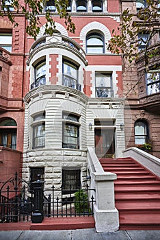 A colorful brownstone building and stoop