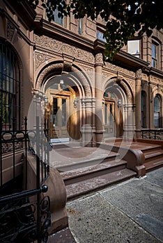 A colorful brownstone building and stoop photo