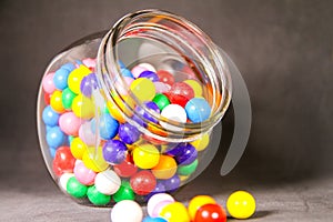 Colorful Bubble Gum Balls in Glass Cannister Black Background