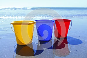 Colorful buckets on beach