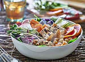 Colorful buddha bowl with grilled tofu and pea shoots