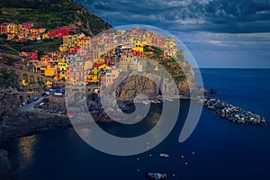 Colorful buildings on the cliffs at evening, Manarola village, Italy