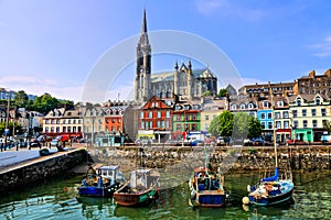 Colorful buildings, old boats and cathedral, Cobh harbor, County Cork, Ireland photo