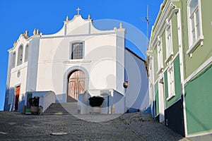 Colorful buildings in the old town of Aljezur with Misericordia church, Costa Vicentina, Algarve photo