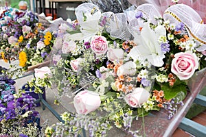 Colorful bunch of pink rose and white lily flowers on a shelf for sell, Bangkok, Thailand