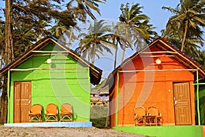 Colorful Bungalows on a Palm Beach in Goa, India.