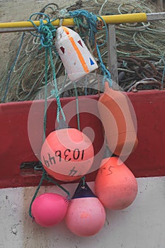 Colorful buoys hanging from fishing boat