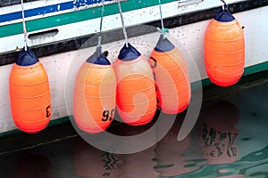 Colorful buoys on the side of a fishing boat.