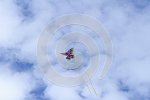 Colorful butterfly kite across a blue sky