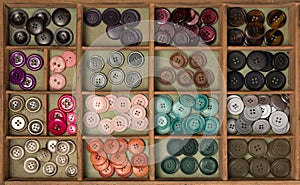 Colorful buttons in a box