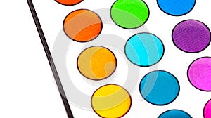 Colorful buttons on a led smart lighting remote control for controlling light hue. Multi colored round buttons pattern closeup