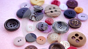 Colorful buttons on pink table