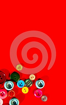 Colorful buttons are scattered over red background.