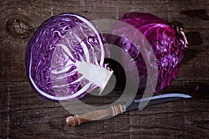 Colorful cabbage cut in half over rustic wooden background