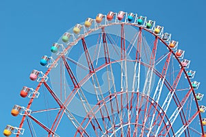 Colorful cabins on a Ferris wheel, blue sky