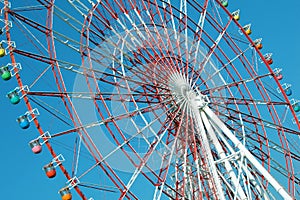 Colorful cabins on a Ferris wheel, blue sky