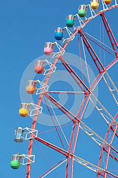 Colorful cabins on a Ferris wheel, blue sky