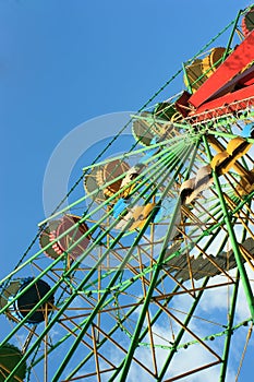 The colorful cabins of Ferris wheel on sky background