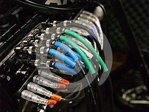 Colorful Cables Plugged into a Sound Board photo