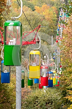 Colorful cableway cabins in autumn city park